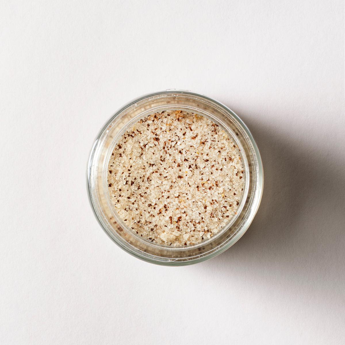 a jar of brown and white salt
